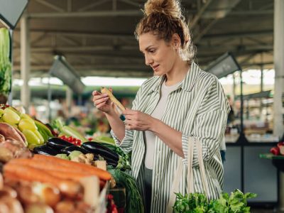 Woman choosing produce for smoothies.